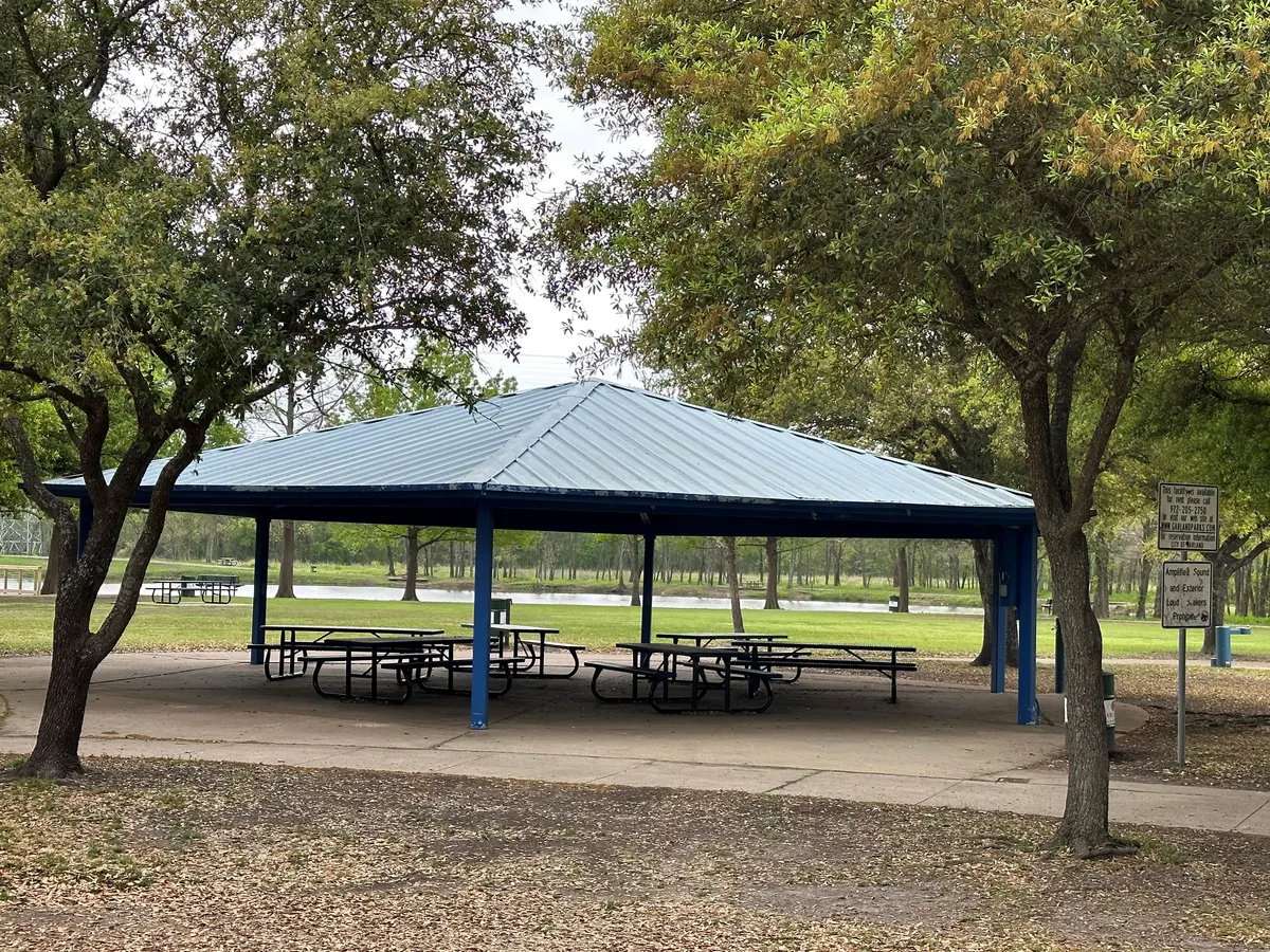 Playground with fishing pier and lakeside views at Ablon Park — Garland, TX