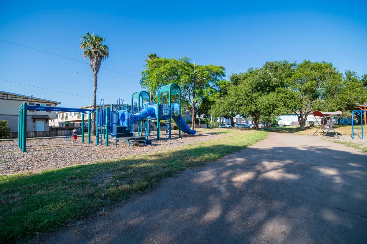 Sand pit and shaded playground at Children's Park — Isla Vista, CA