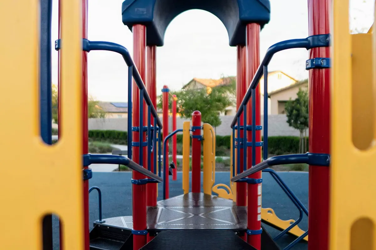 Colorful playground equipment in a community park on a sunny day