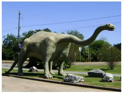Life-size dinosaur statue and playground at Dinosaur Park — Wharton, TX