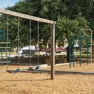 Wood-chip surfaced playground and pavilion at Helotes City Park — Helotes, TX