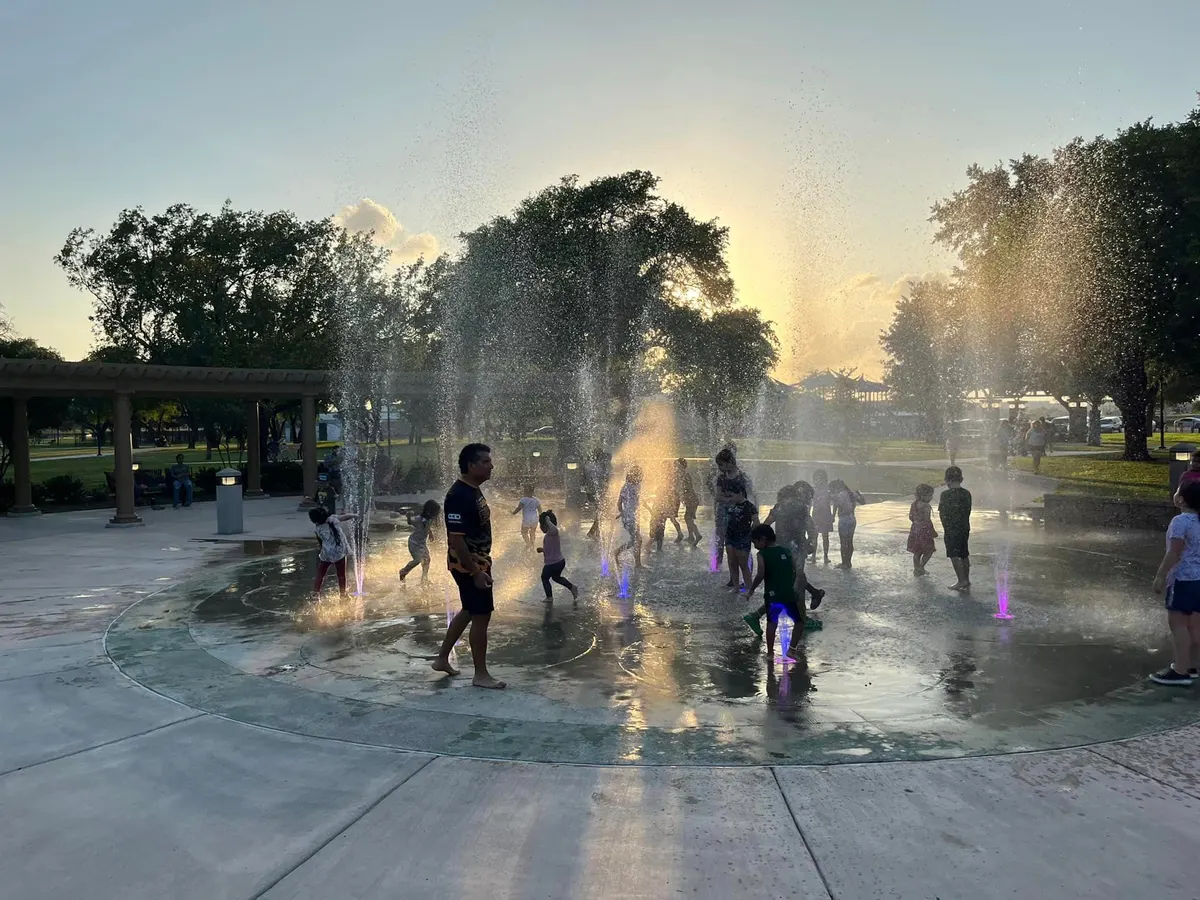 Lon C. Hill Park splash pad with LED lights and water jets at golden hour — Harlingen TX