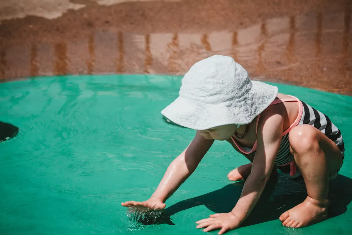 Young child playing in shallow water at a spray ground