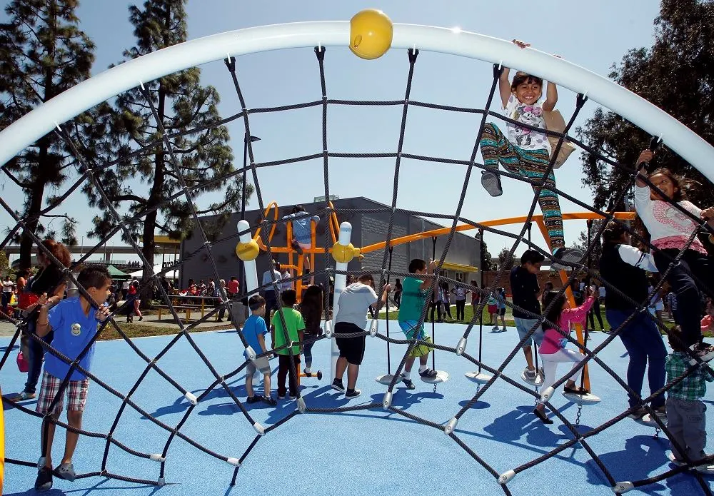 Miraloma Park playground with climbing nets and rubber surface — Anaheim, CA