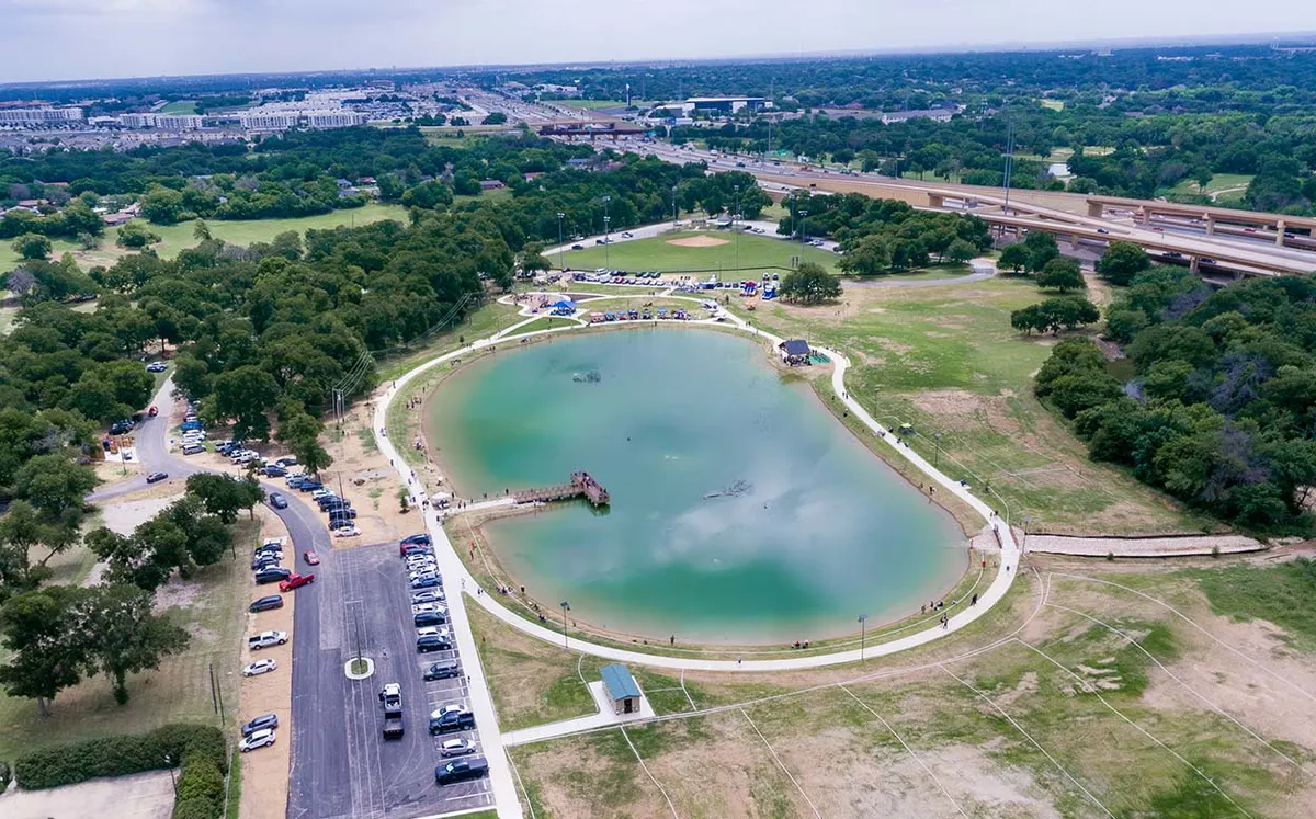 Playground equipment at North Park with fishing pond views — Haltom City, TX