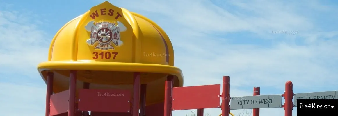 Fire station-themed playground with climbing tower at Parker's Park — West, TX