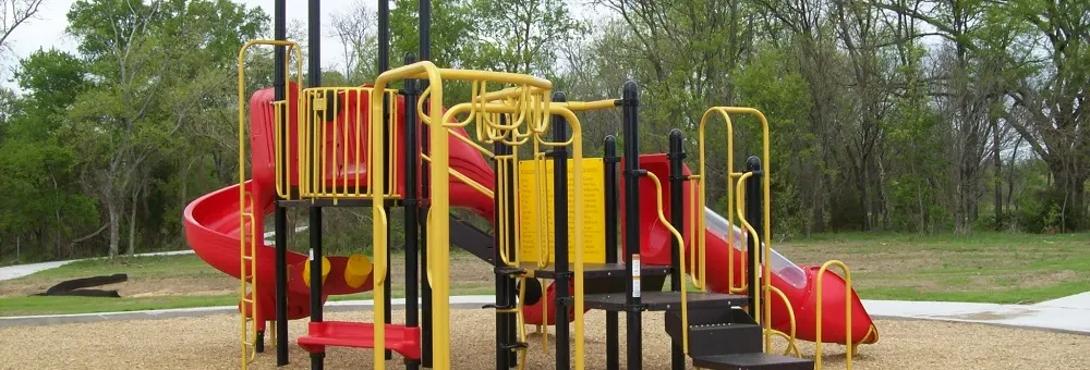 Playground and wooded setting at Pecan Grove Park — Sherman, TX