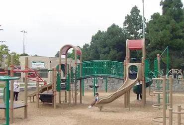 Playground next to flower-shaped water showers at Ponderosa Park — Anaheim, CA