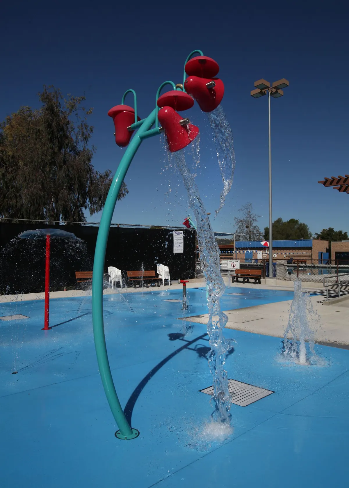 Poway Community Swim Center splash pad with geysers and overhead buckets — Poway, CA