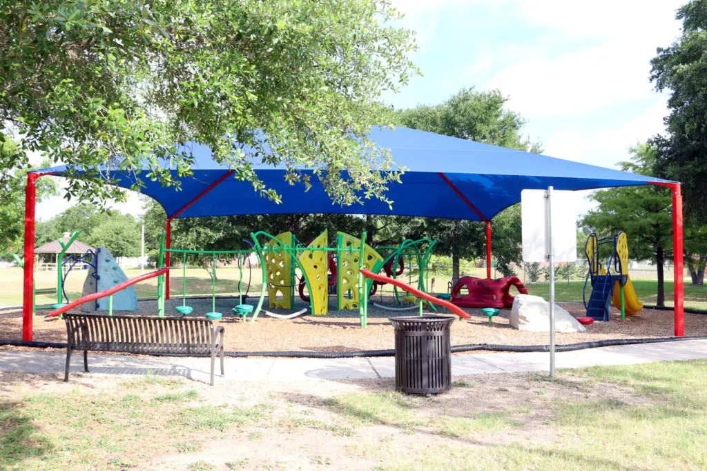Climbers and slides at Pryor Smith Park playground — Kirby, TX