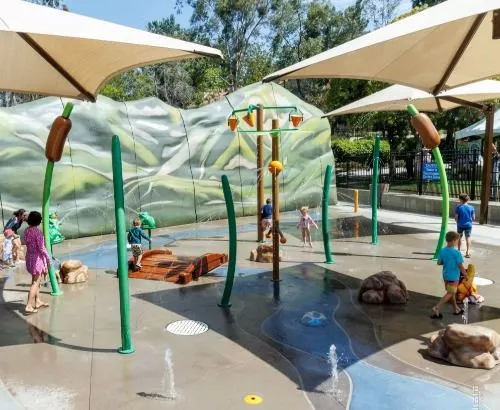 Train playground with boxcars and play structures at RSM Central Park — Rancho Santa Margarita, CA
