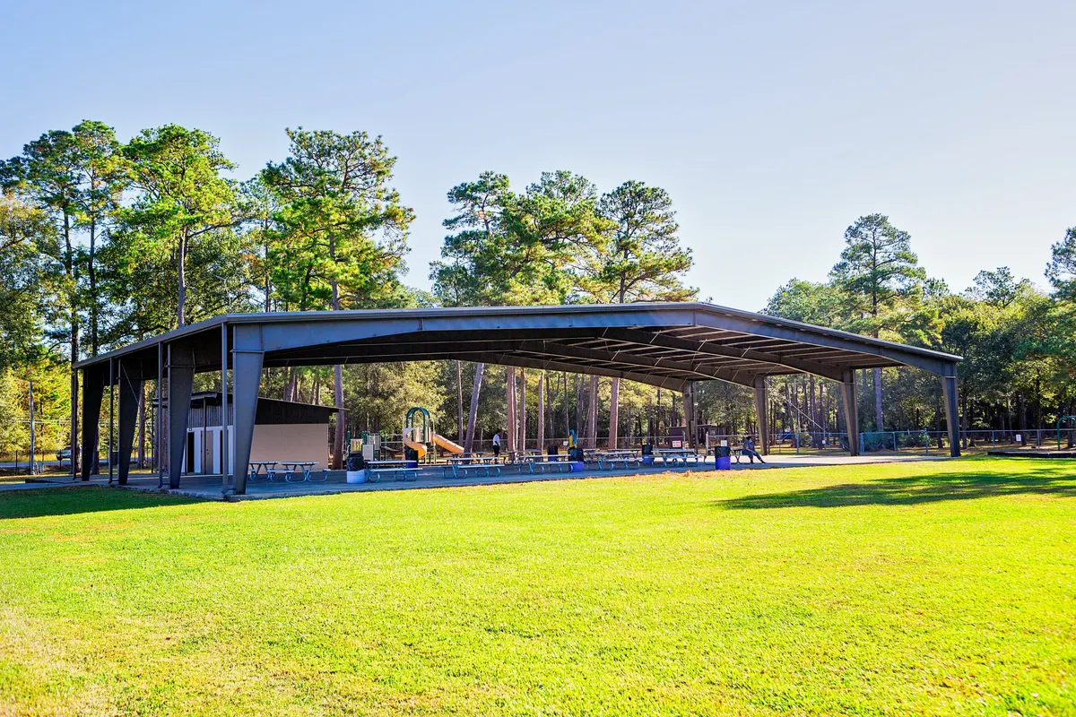 Shaded playground and open-air pavilion at Schott Park — Humble, TX