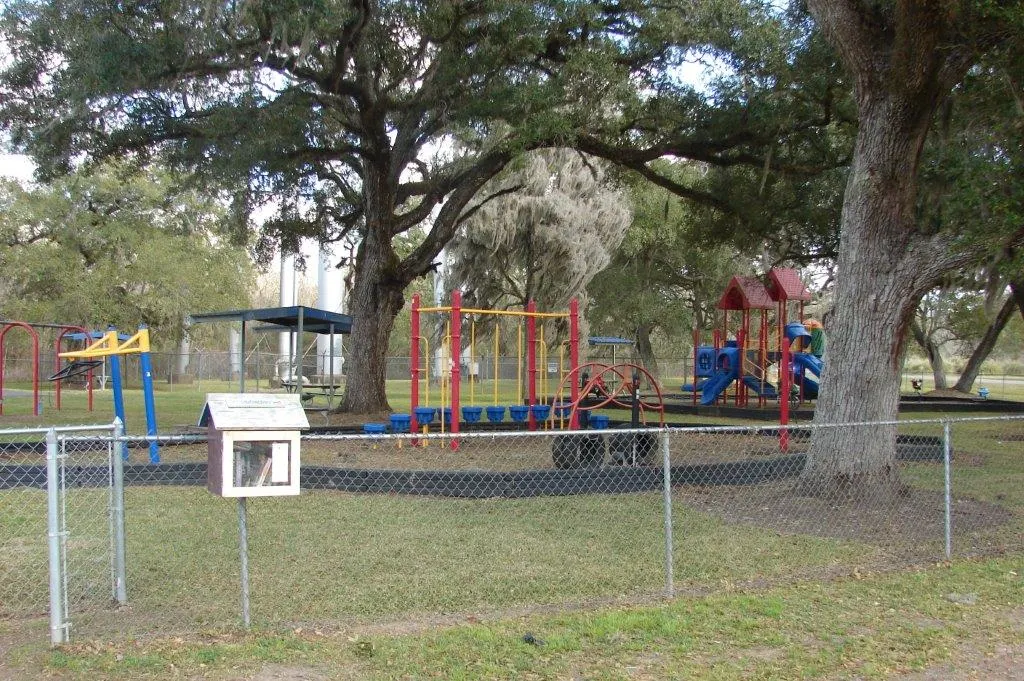 Shaded playground under mature trees at Wilson City Park — Brazoria, TX
