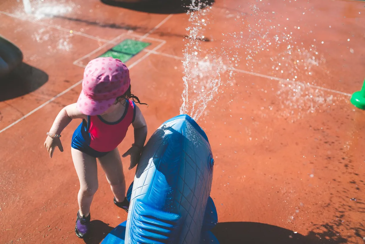 Kids playing in a splash pad water play area