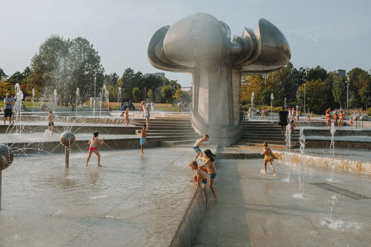 Kids splashing at an urban water fountain park